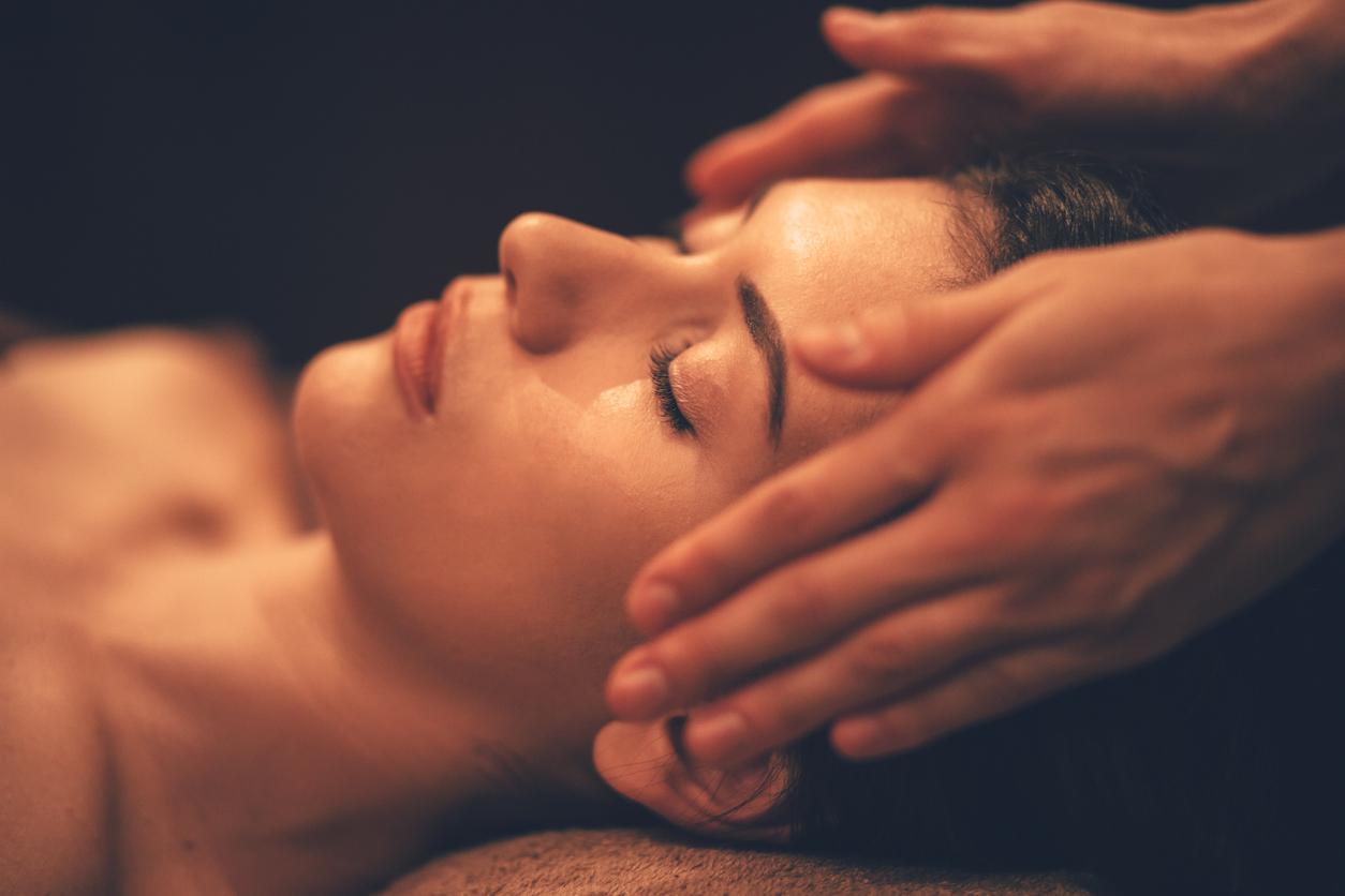 Young woman getting head massage at day spa salon  istock 913090502